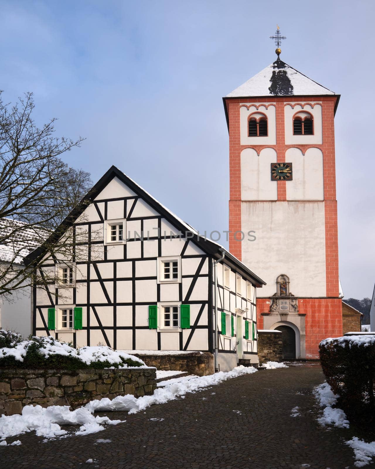 Center of village Odenthal with parish church and old buildings on a winter day, Germany