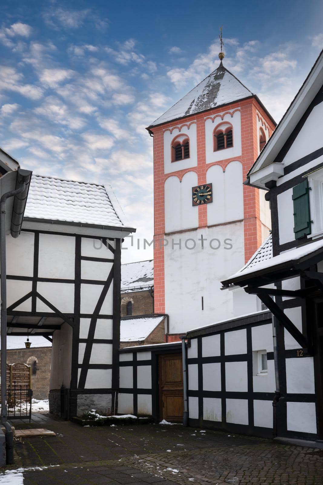 Center of village Odenthal with parish church and old buildings on a winter day, Germany