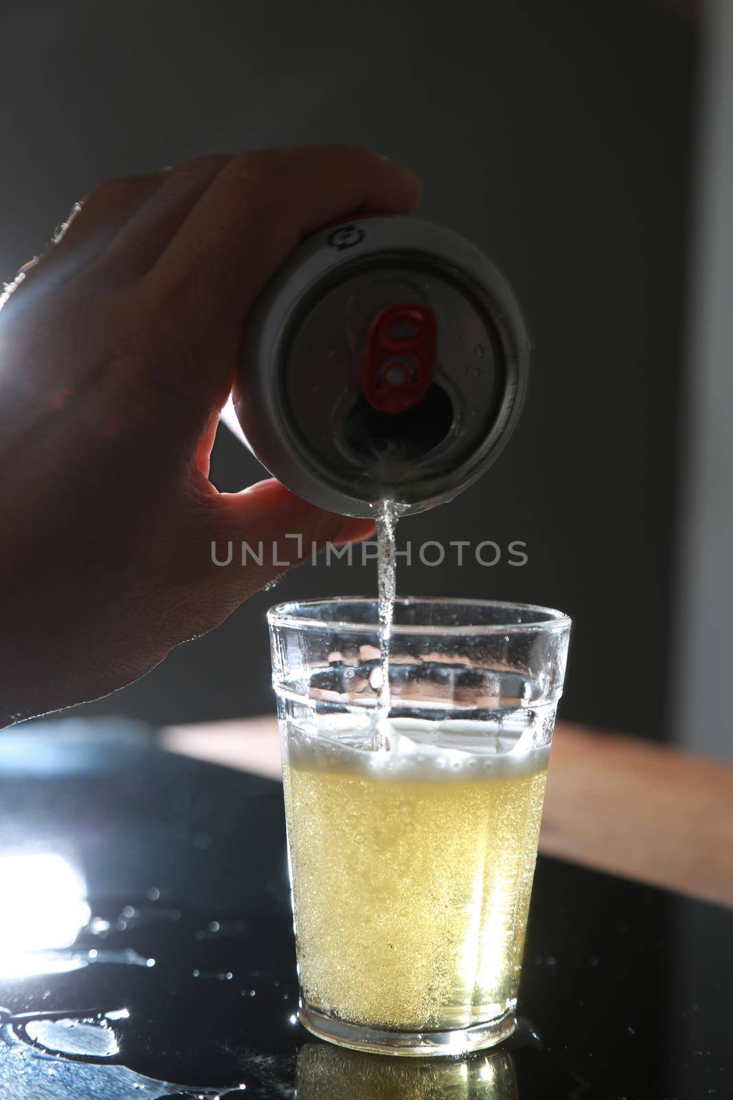 salvador, bahia / brazil - june 29, 2015: Beer bottle on bar table next to a driver's license and vehicle key, symbolizing drink consumption by vehicle drivers.