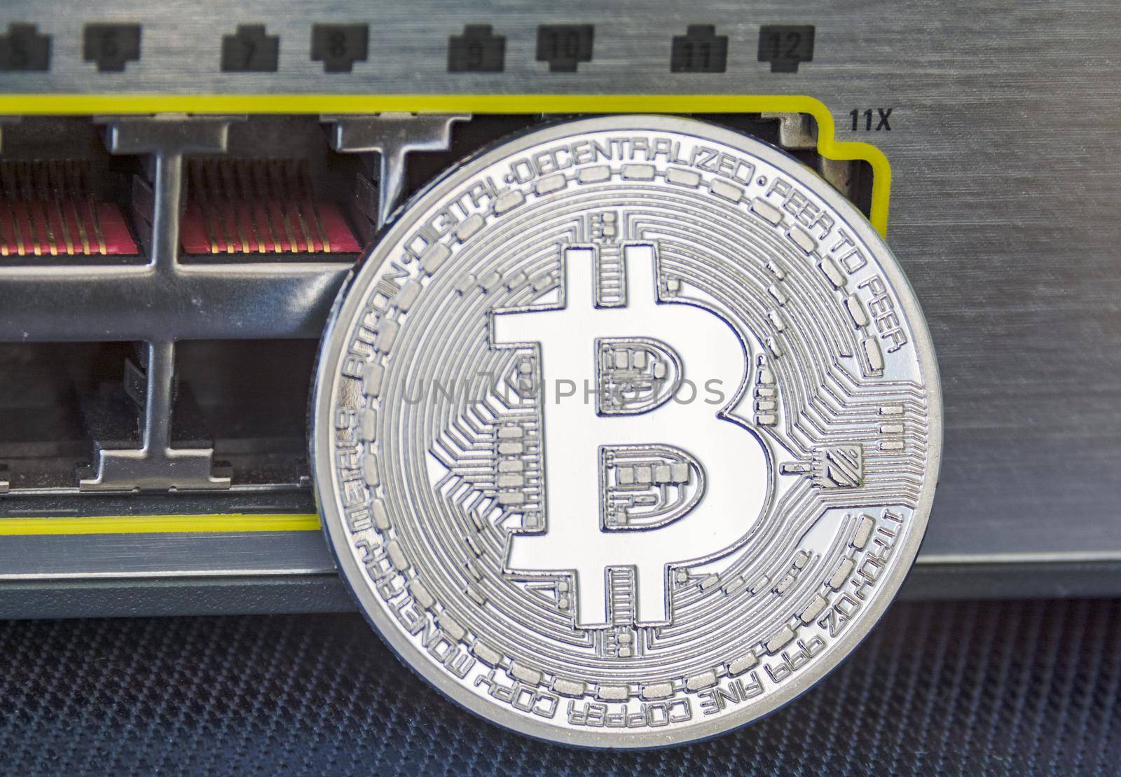 Enlighted metal bitcoin on ethernet ports background