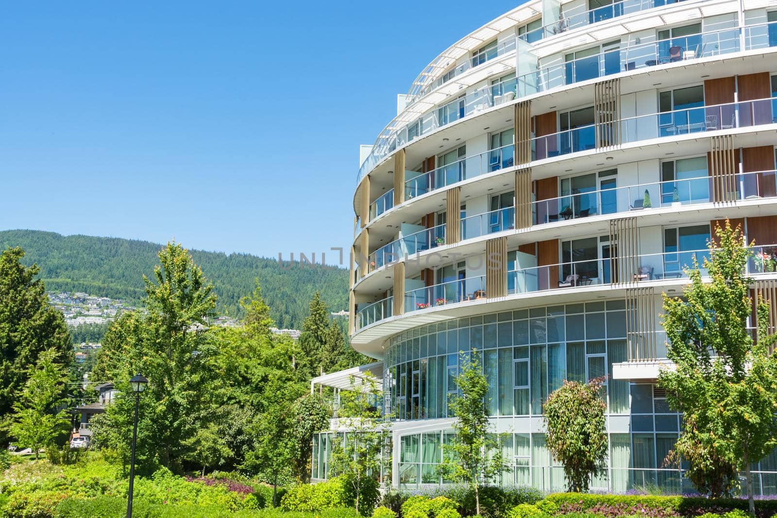 Round shaped front facade of residential building with mountain view and blue sky background