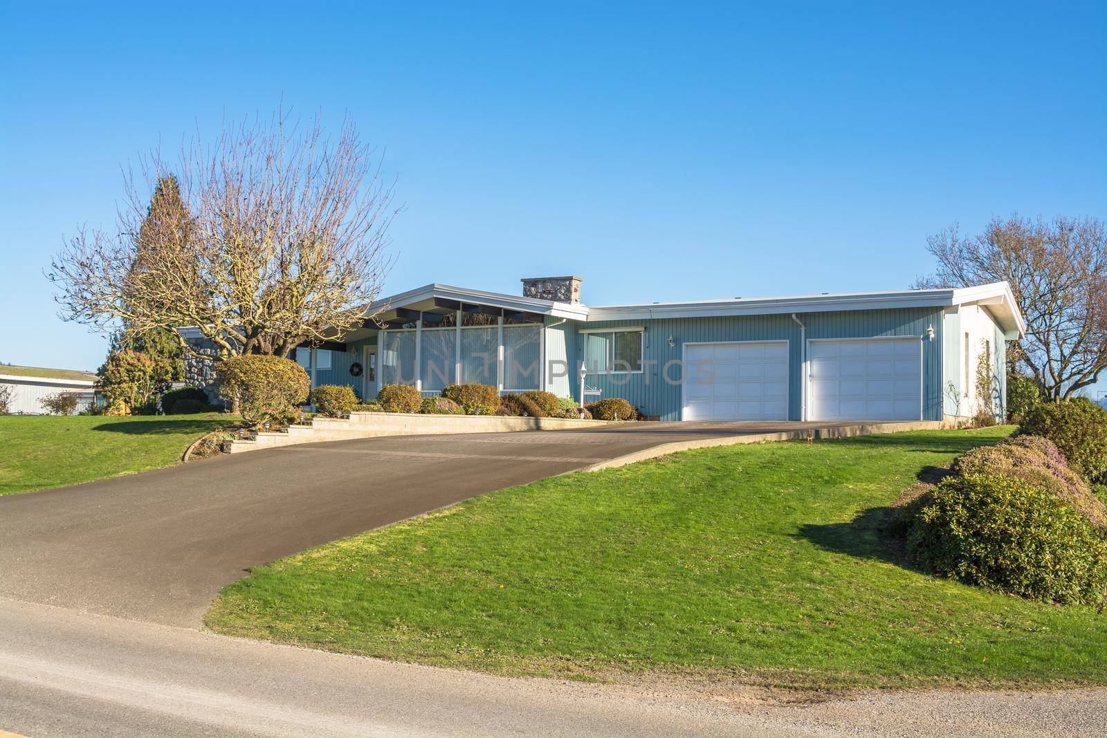 Big family house on the hill with double gates garage and asphalt driveway in front