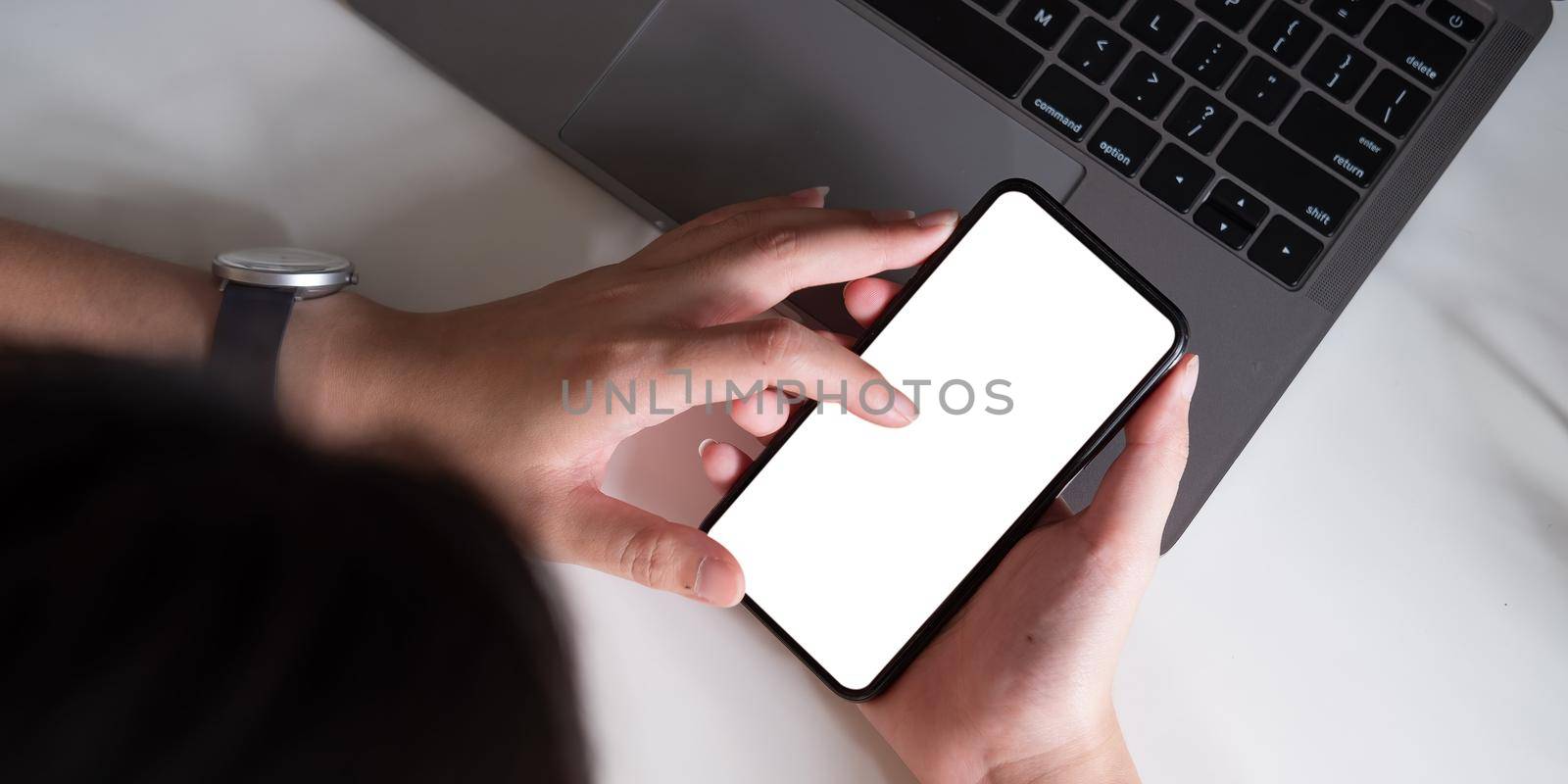 Top view Woman sitting and holding blank screen mock up mobile phone by nateemee