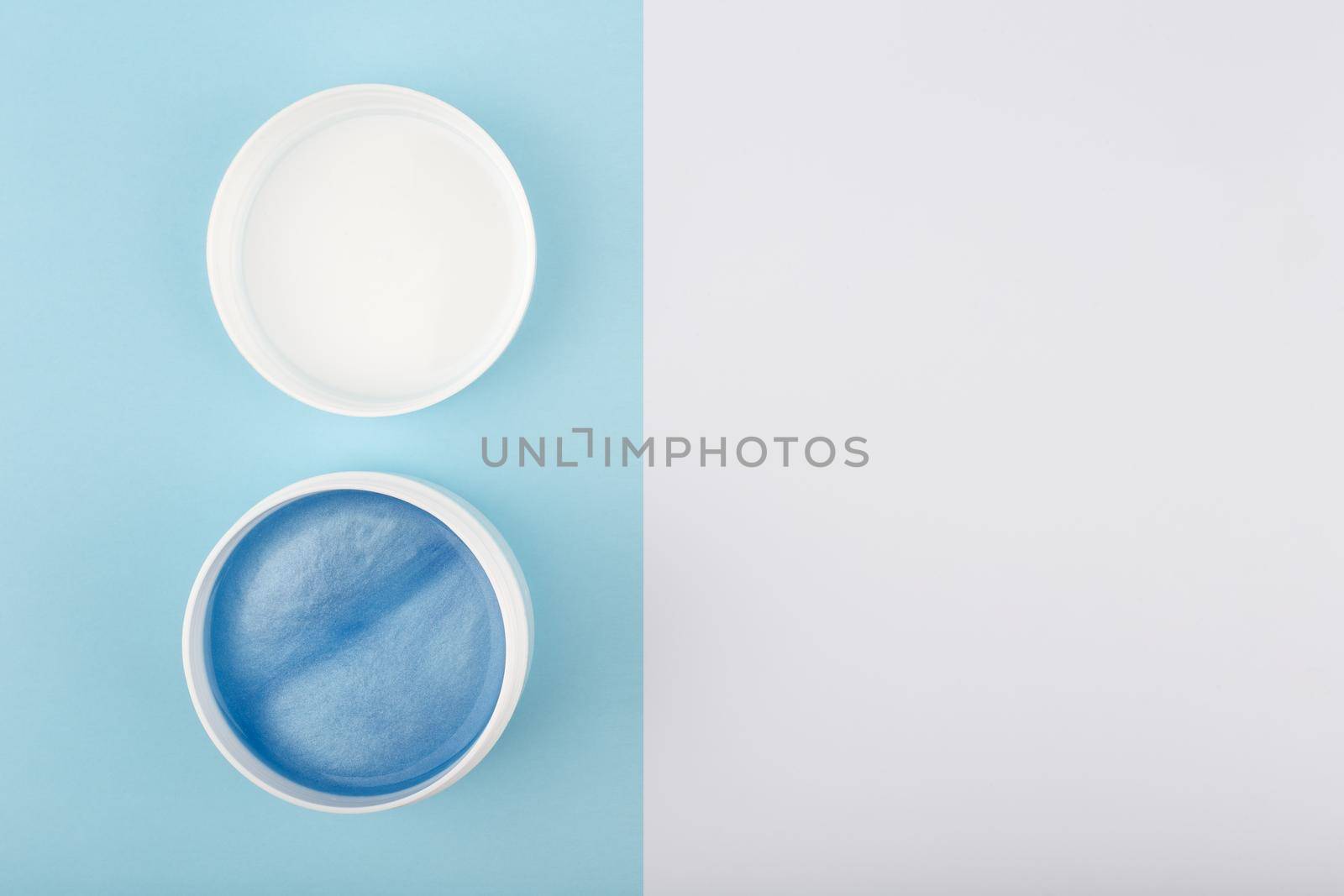 Flat lay with opened face mask with sea minerals on blue and white background with copy space. Concept of natural beauty products with sea minerals