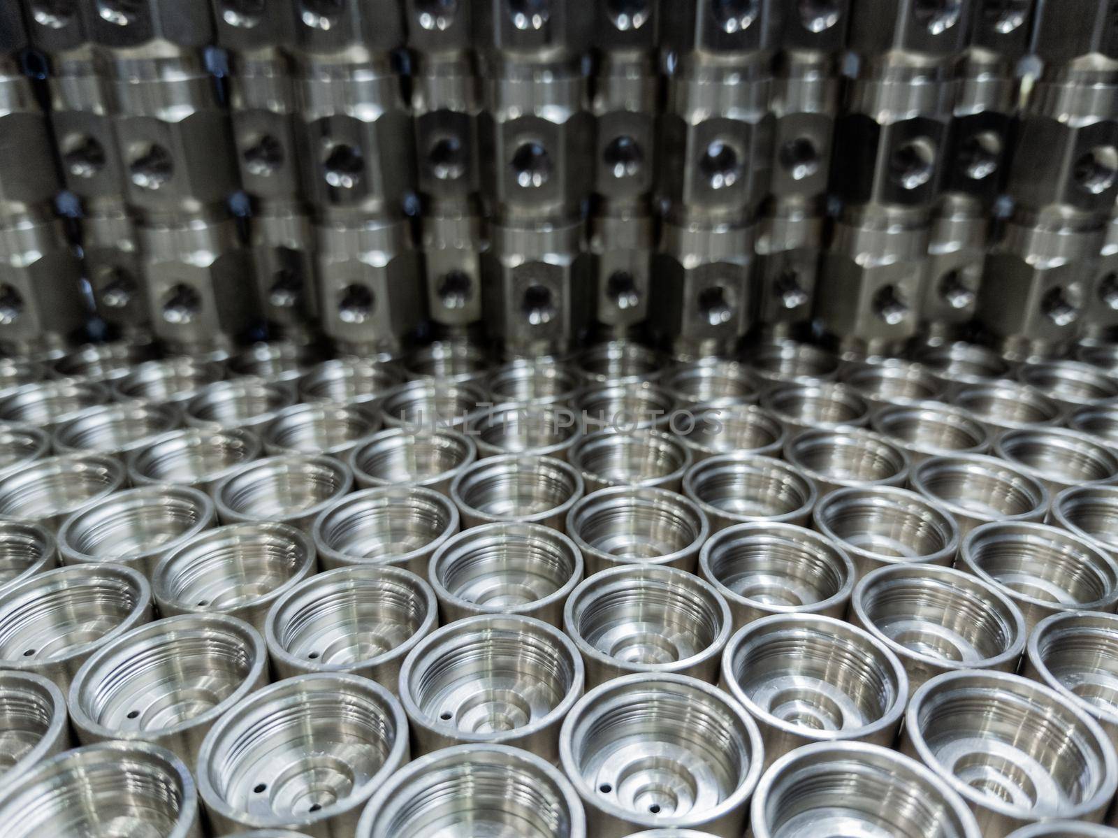 shiny steel industrial production parts after turning - close-up with selective focus