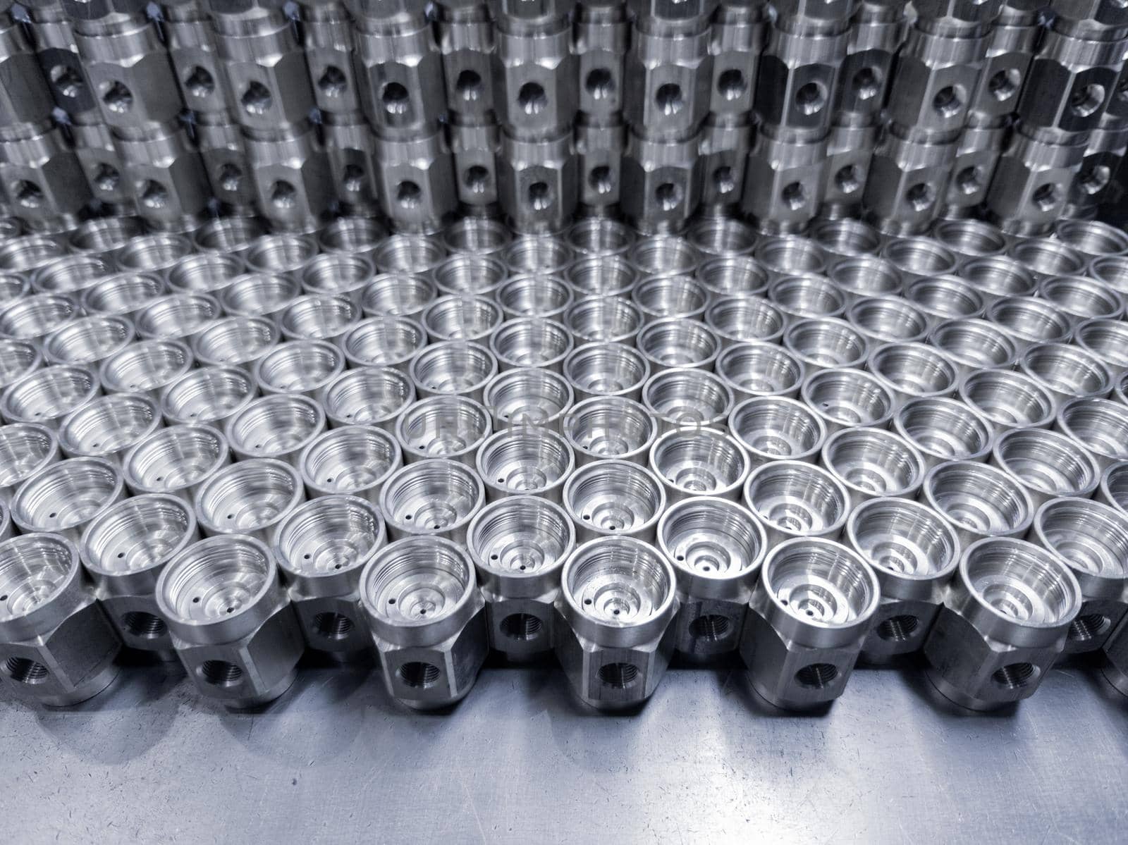 shiny machined metal parts - close-up industrial background with selective focus