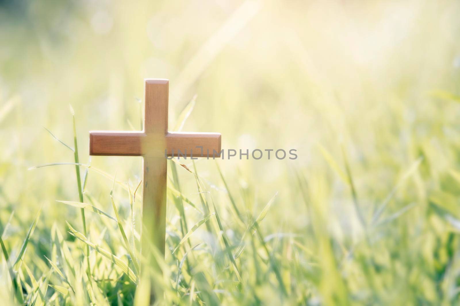 Cross on blurry sunset background. Christian, Christianity, Religion copyspace background.
