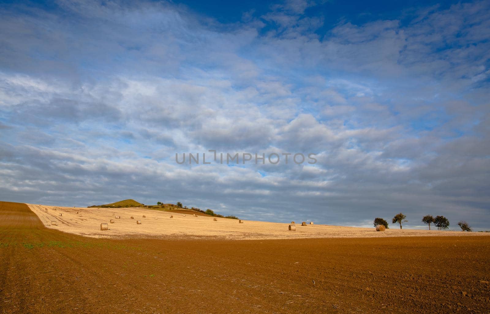 Straw bales on a stubble in Central Bohemian Uplands, Czech Republic. Field landscape bales of straw on a farm field