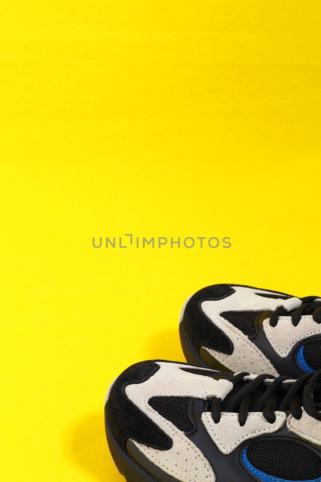 Women's sneakers are in isolation on a yellow background with a place for inscription. by Olga26