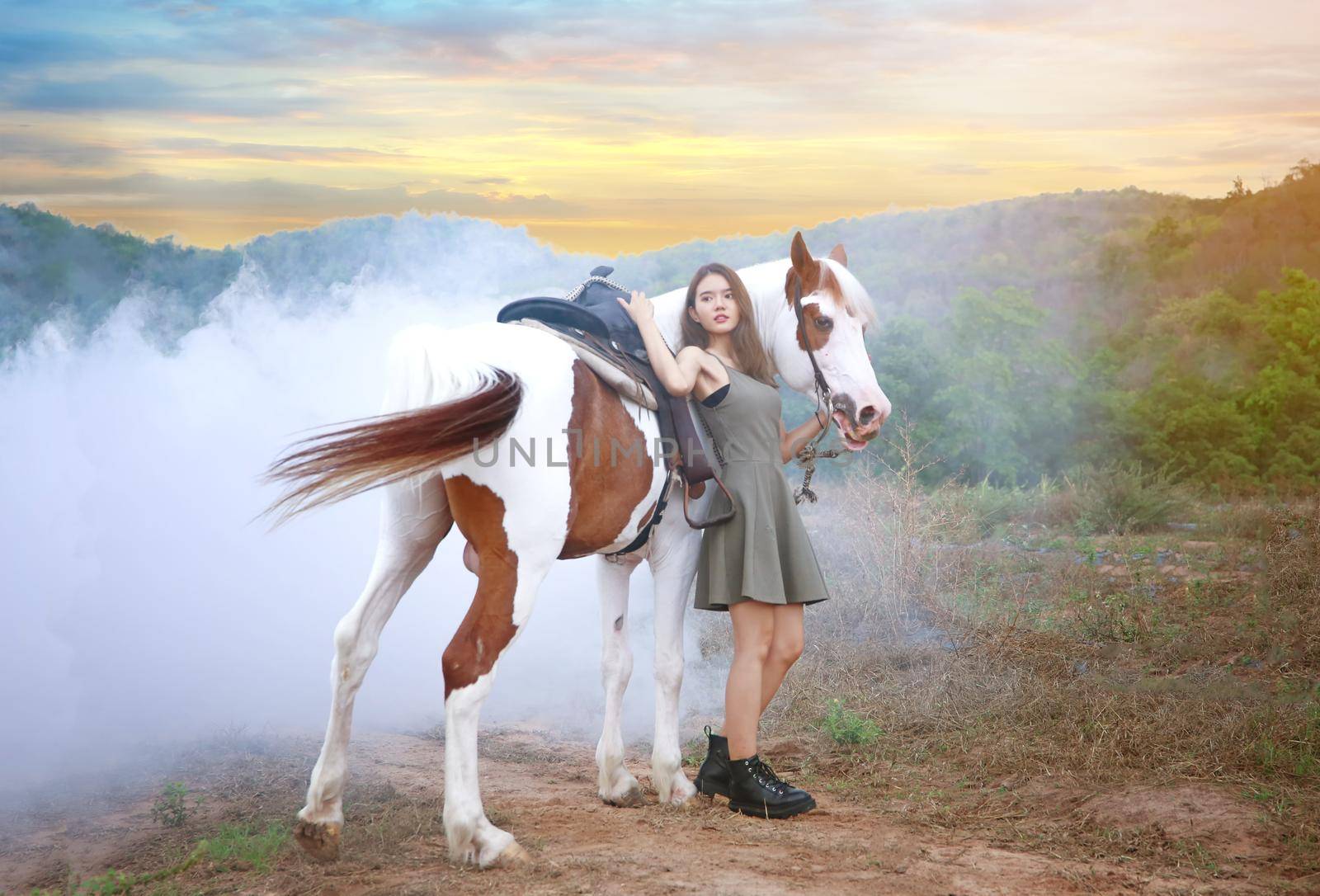 Woman with horse standing on field
