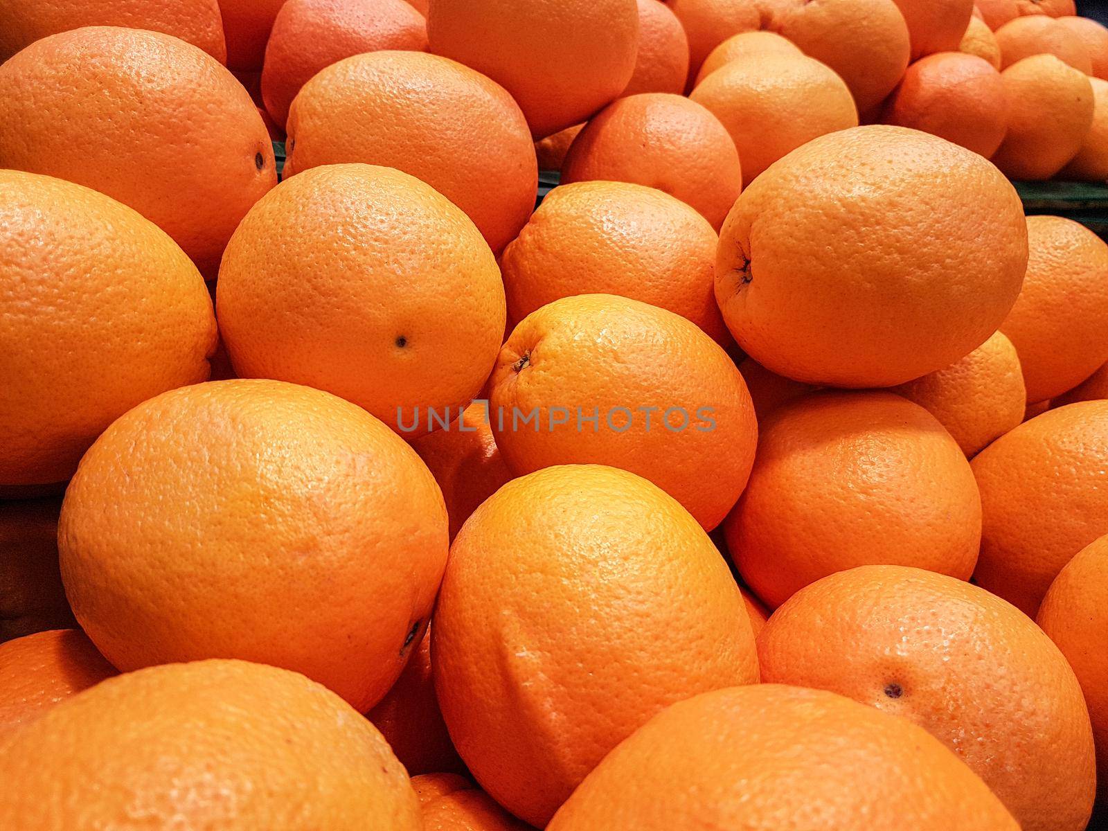 Close-up of a fresh orange fruits for sale as an agricultural background or texture.