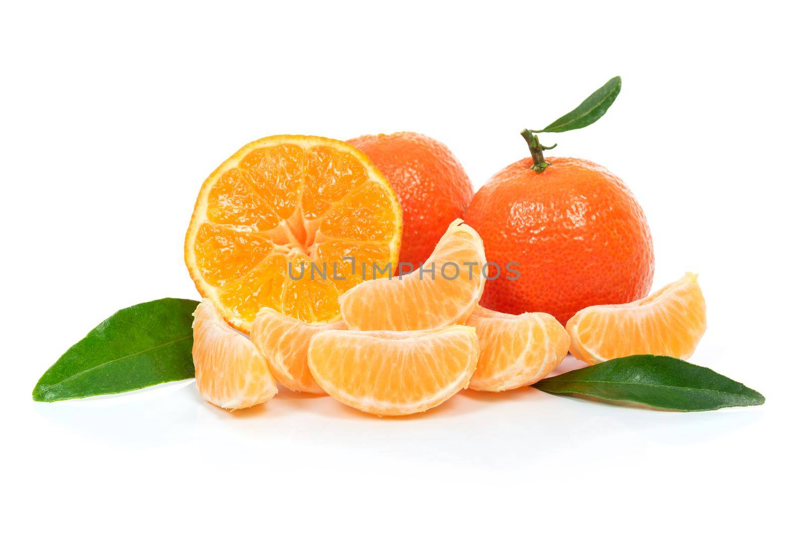 Tropical fruit composition - fresh  fruits and pieces of orange or tangerine with leaves isolated on a white background