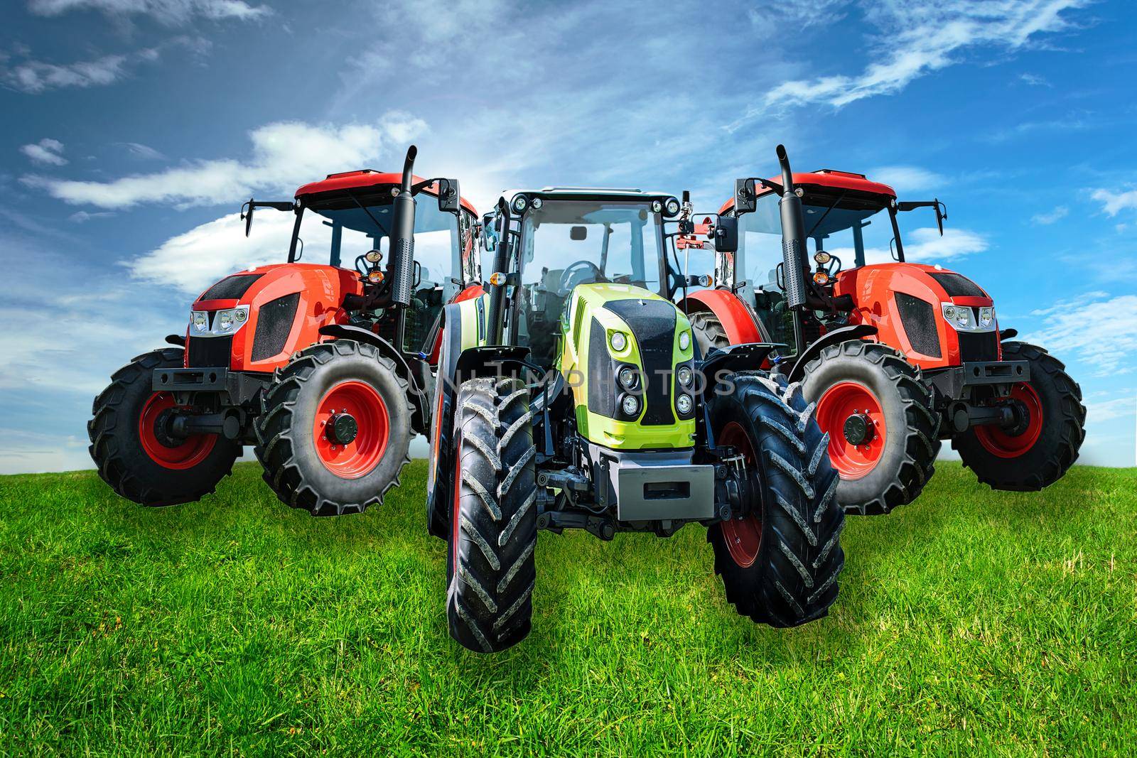 Group of new and modern agricultural generic tractors on a green meadow in sunny day(mixed)