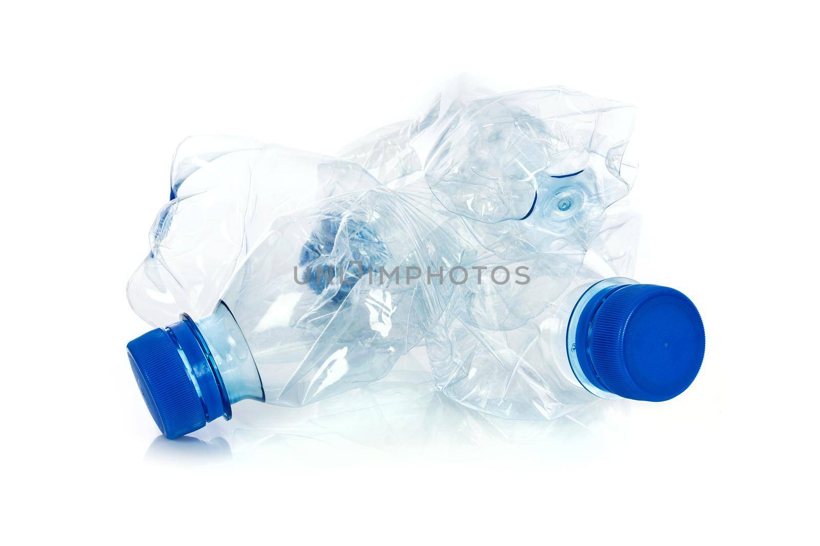 Environmental pollution concept - crumpled plastic bottles isolated on a white background in close-up