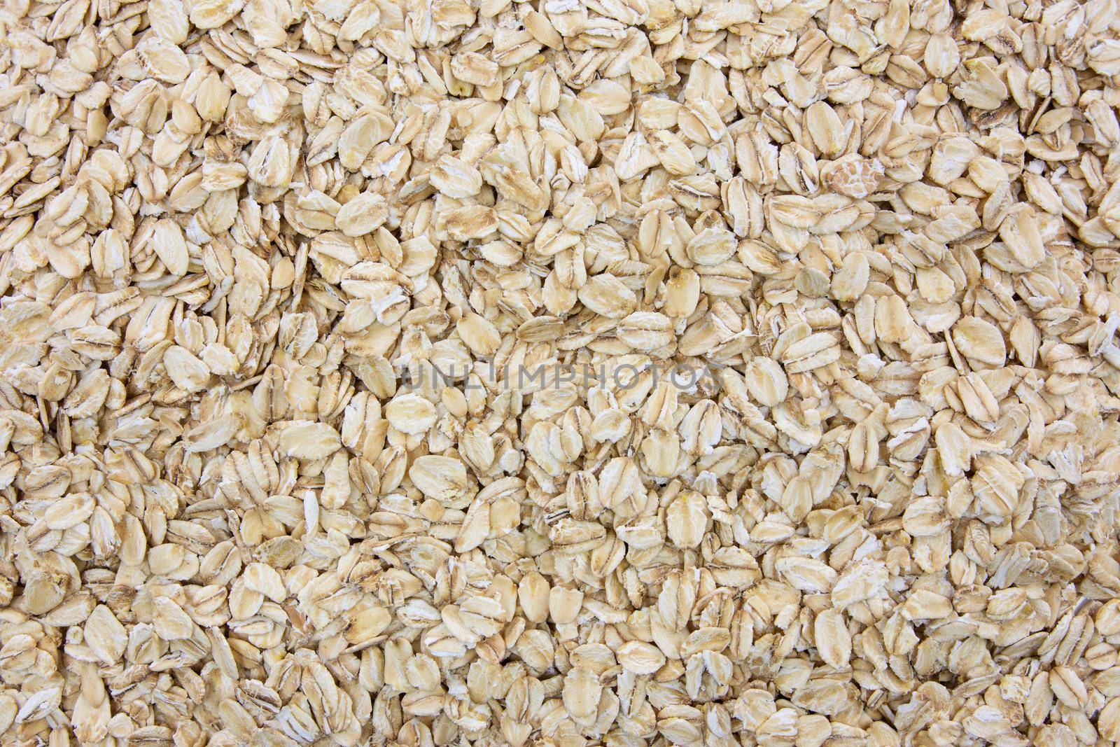 Top view of oatmeal flakes in close-up as a background or full frame texture (high details)