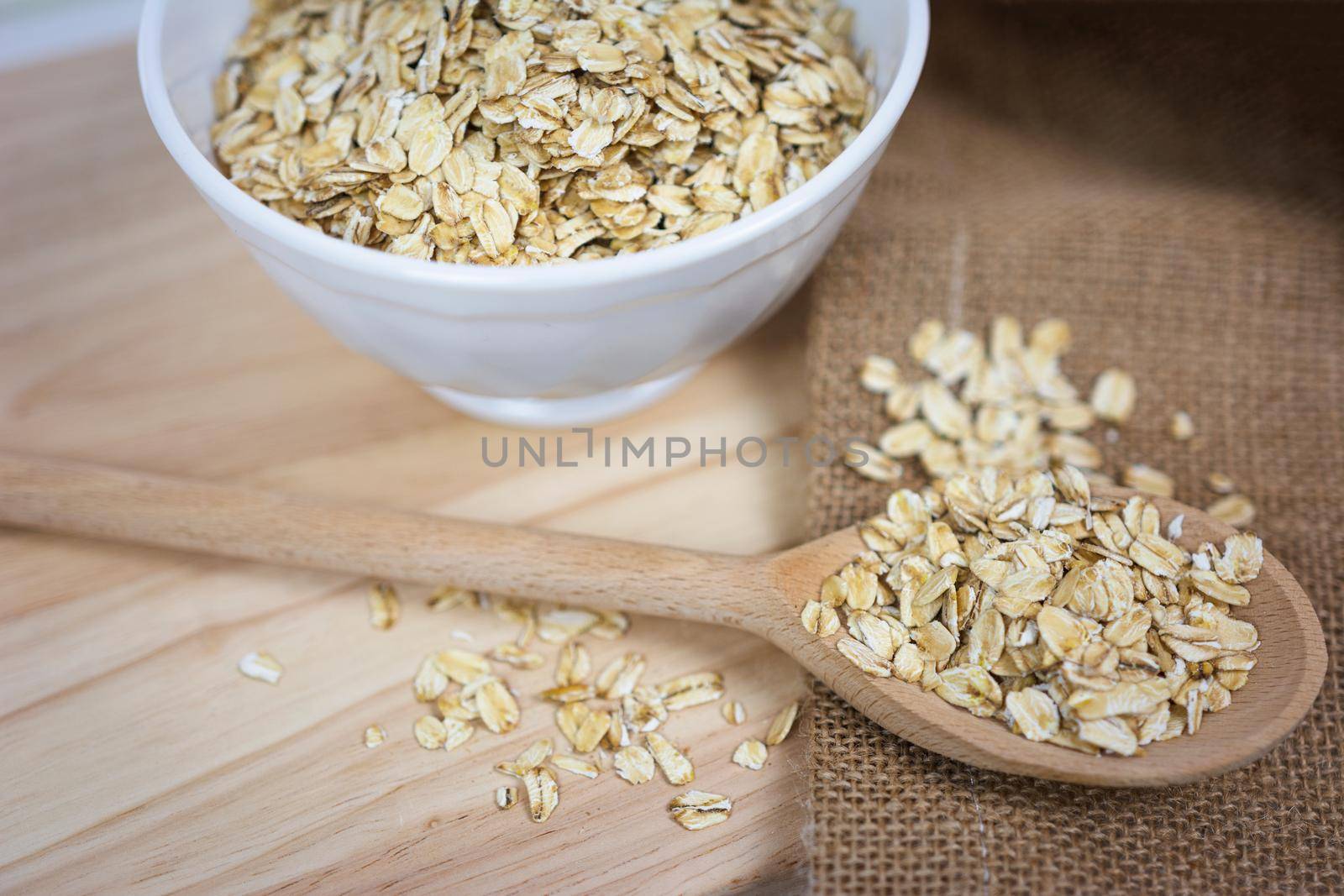 Oatmeal flakes on a wooden table in a rustic style