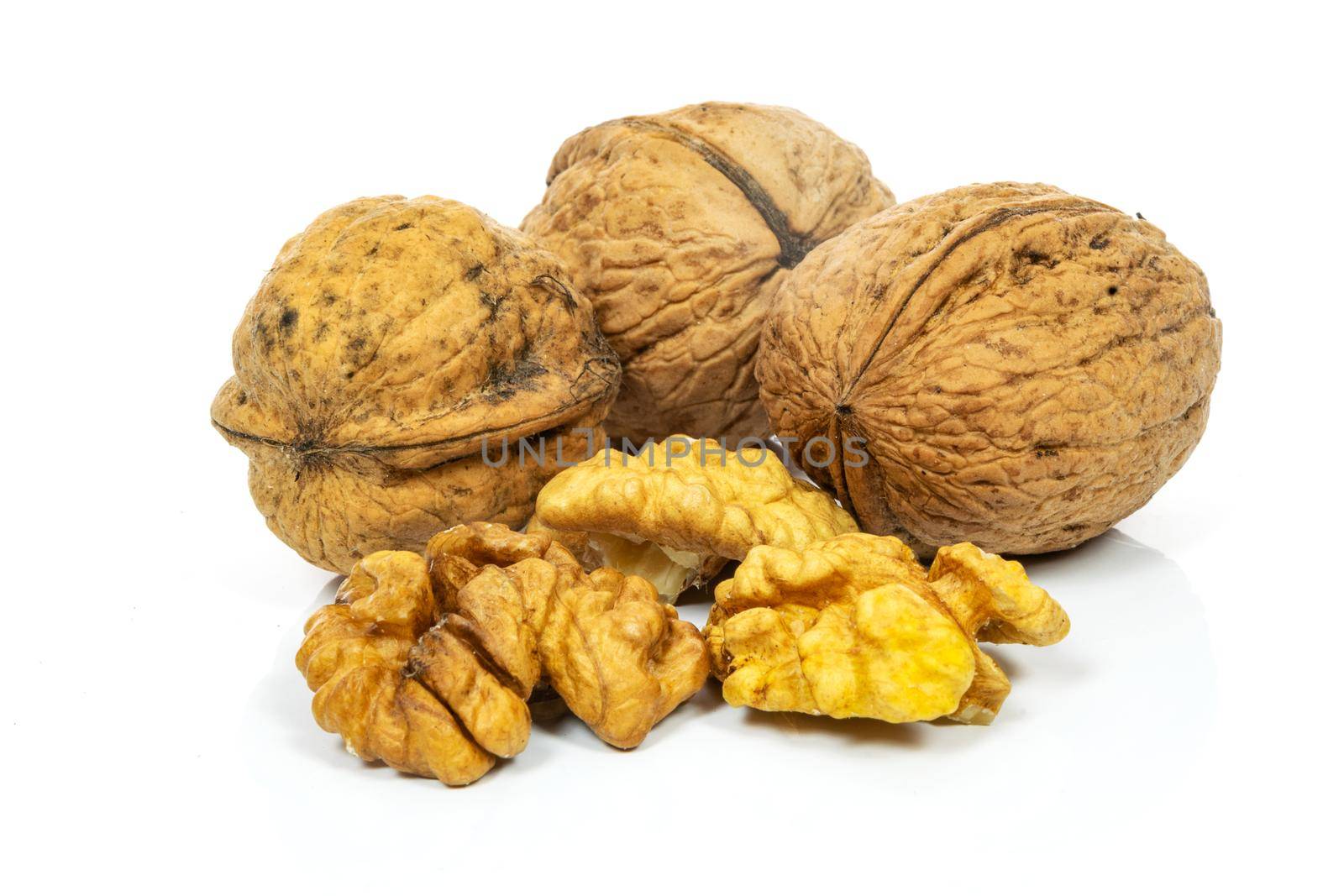 Group of whole shells and shelled walnuts isolated on white background