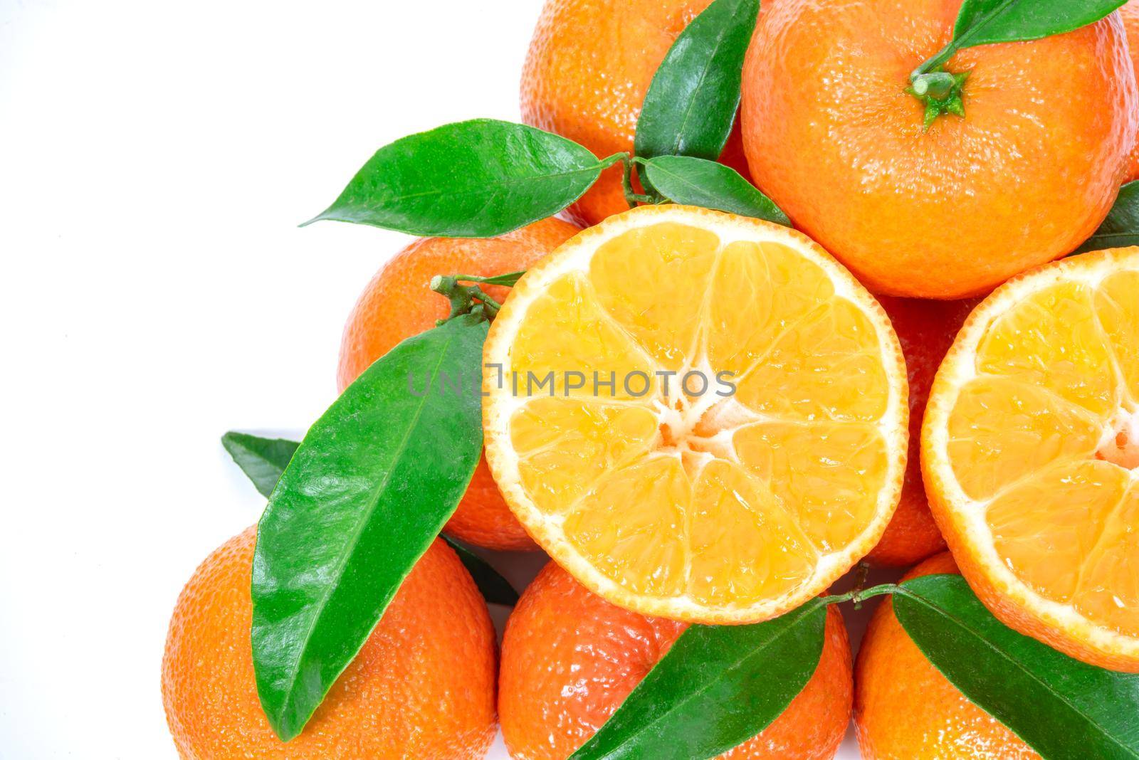 Tropical fruit composition - group of fresh oranges or tangerines  isolated on a white background