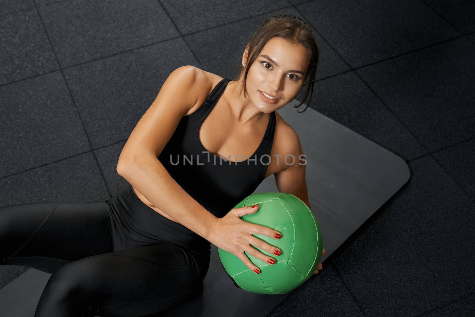 Attractive young woman doing cardion exercise on mat. by SerhiiBobyk