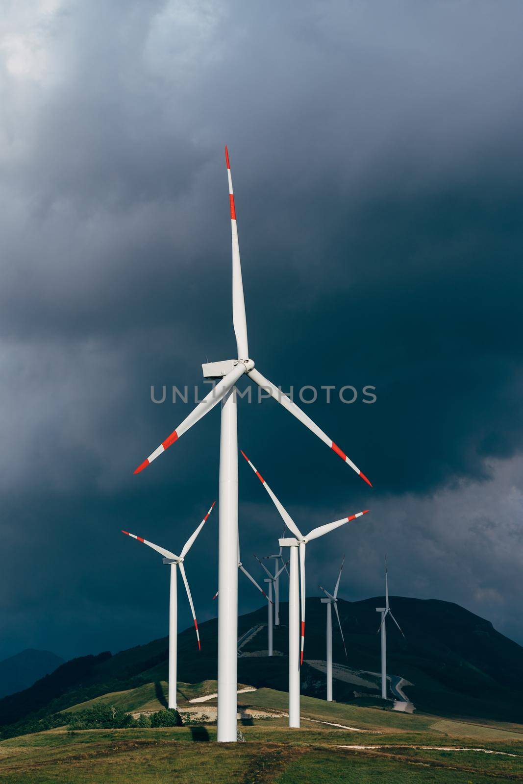 High wind turbines against the lead sky. High quality photo