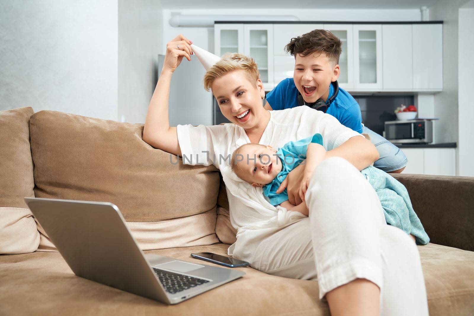 Woman with her two sons having video chat on laptop by SerhiiBobyk
