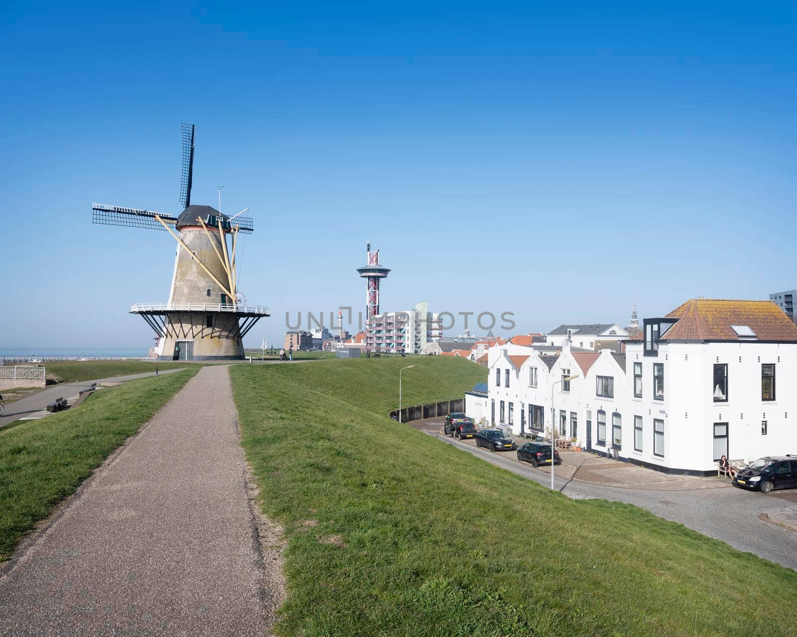 vlissingen, 31 march 2021: windmill near uncle beach and dutch town of vlissingen on sunny day in spring in the netherlands