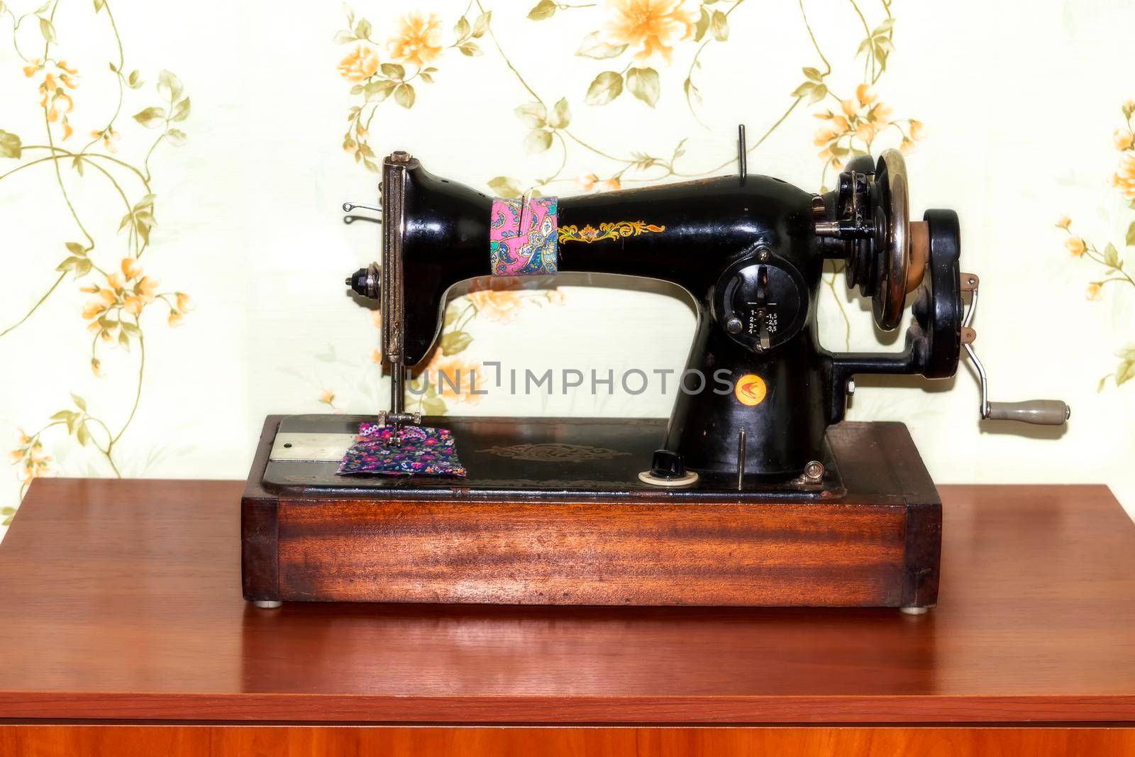 A handmade old sewing machine. Indoors. Front view. Flash light. Crimea, Sudak - 10 October 2020. by Essffes