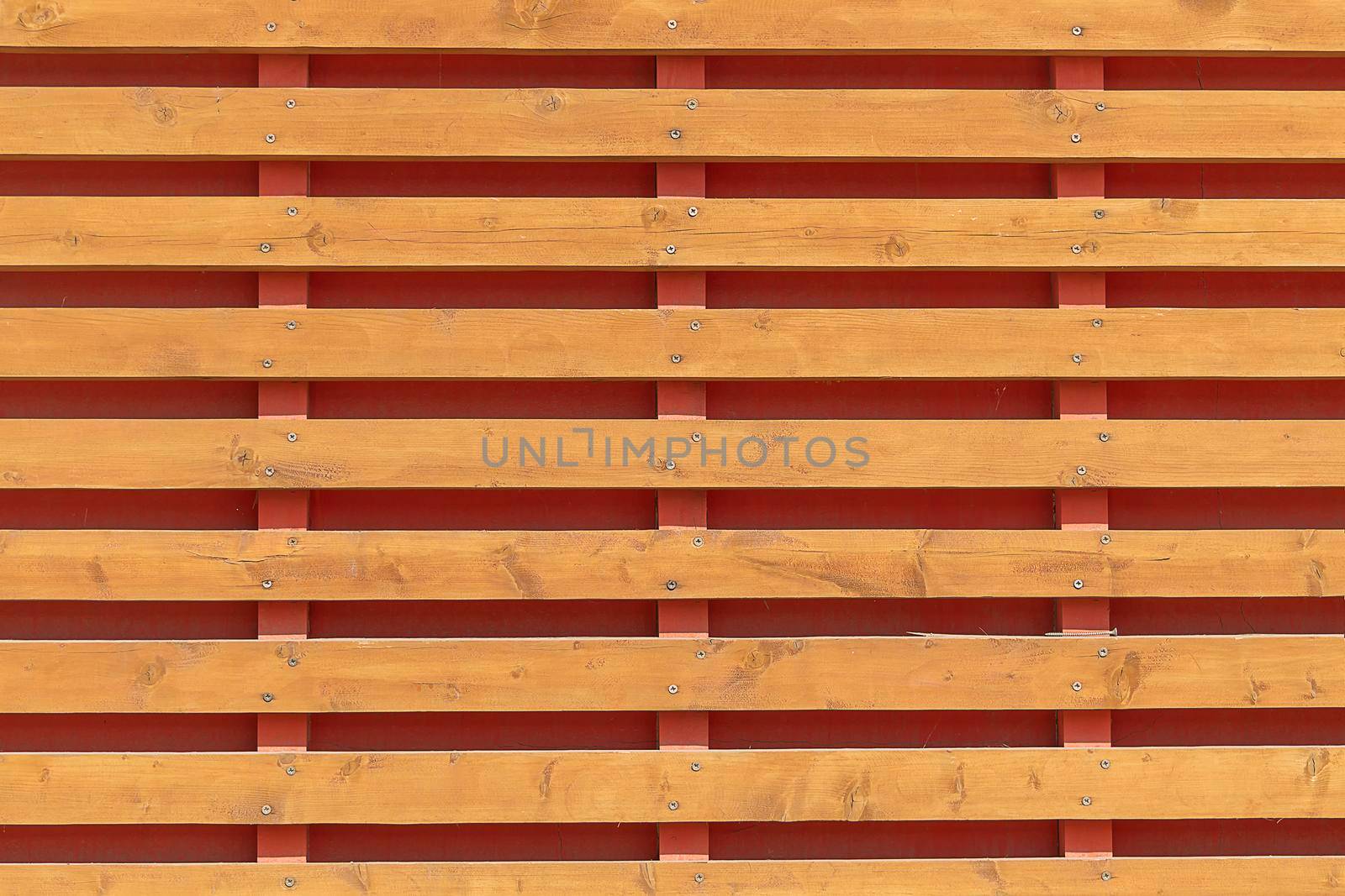 The horizontal planks are wooden. background. Sunny autumn day. Front view. by Essffes