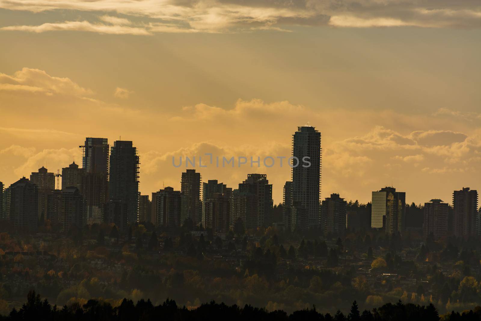 Downtown towers silhouette on sunset sky background