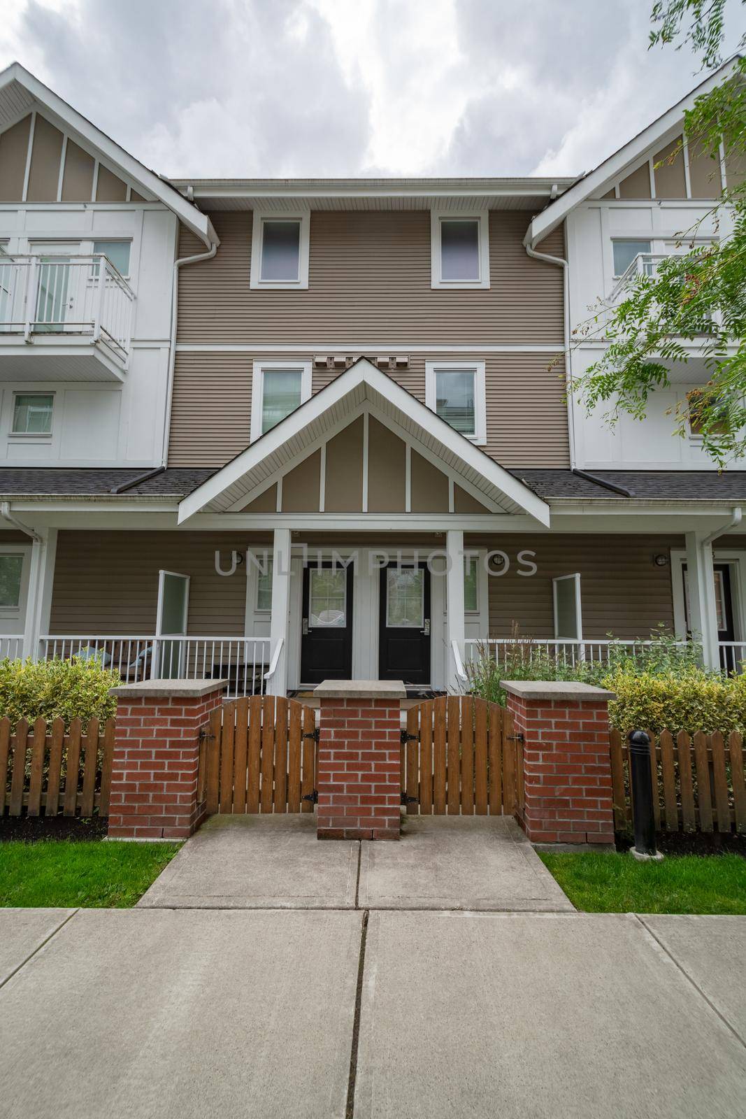 Entrance doors of residential townhouses under the porch. Attached residential townhomes entrance