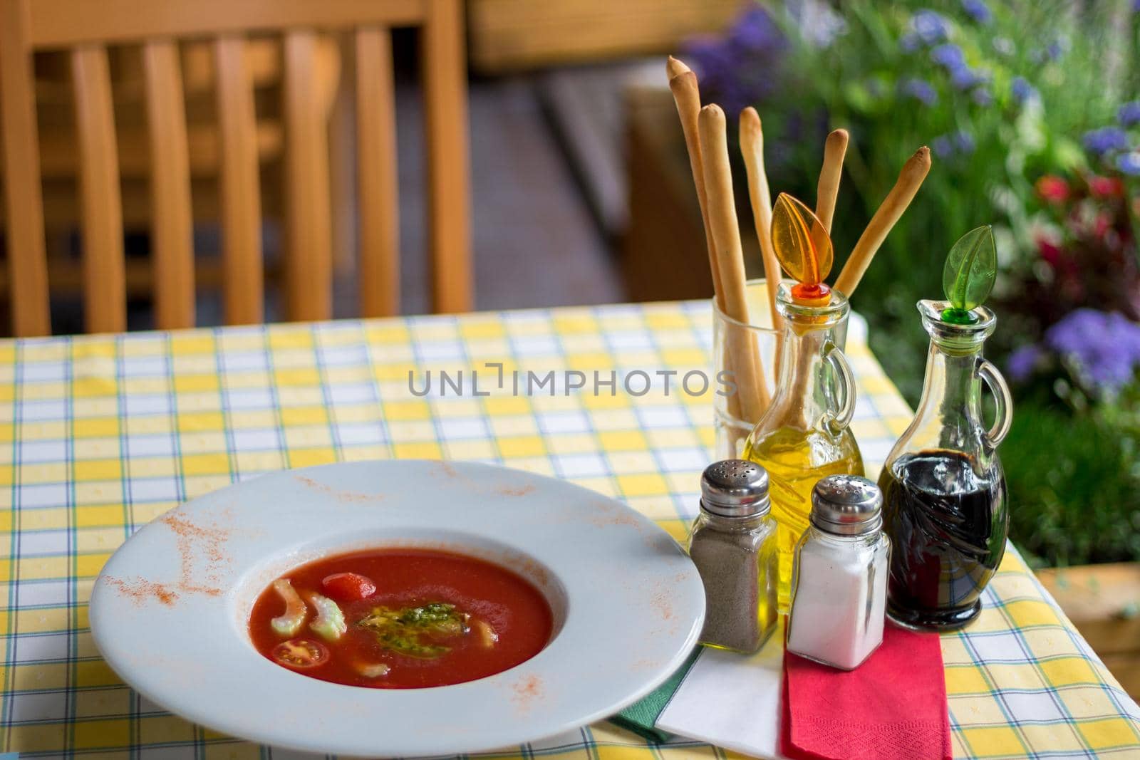 Italian serving. Table set of olive oil, bread sticks, salt, pepper, soy sauce, vinegar, gaspacho tomato soup by VeraVerano