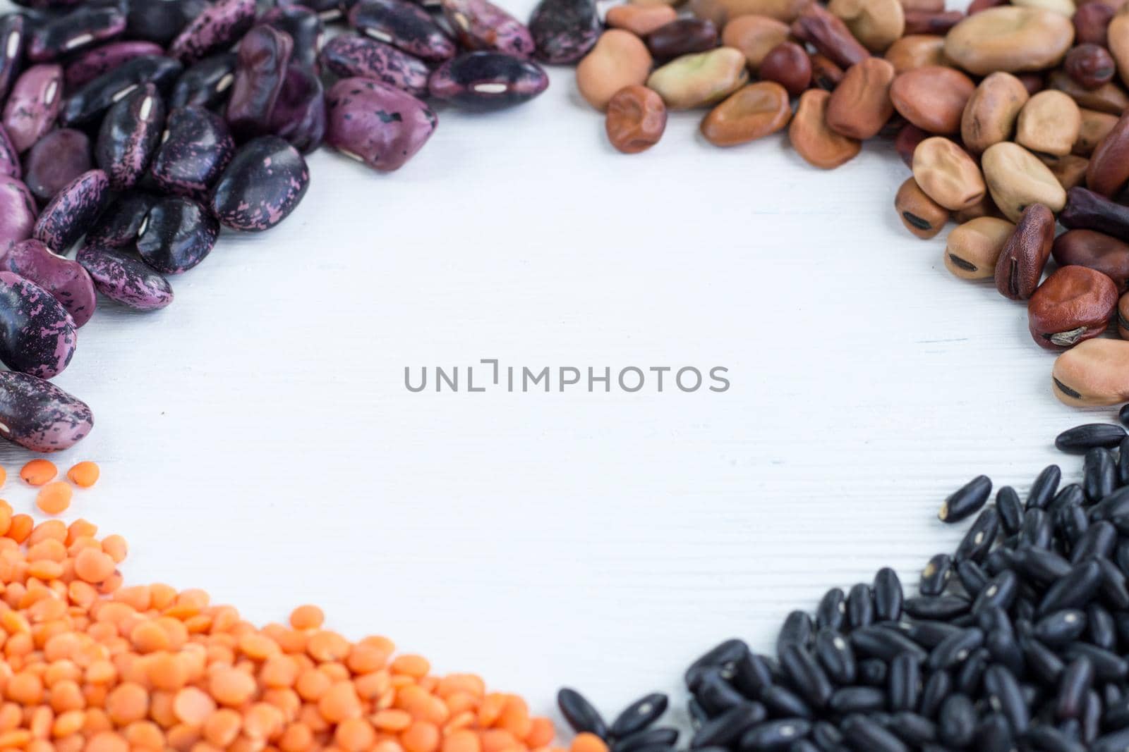 Multicolored background of organic vegan grain food cereal bean lentils ingredients mix with copy-space by VeraVerano