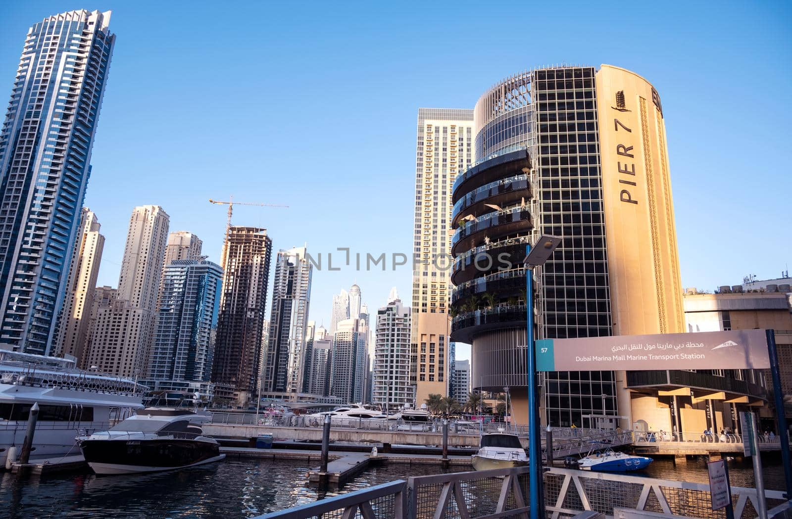 Dec 28, 2020 ,Dubai,UAE.Panoramic view of the beautiful Pier 7 restaurants in Dubai Marina luxury touristic district with Marina Mall and canal with yachts on background. Dubai Marina. by sriyapixels