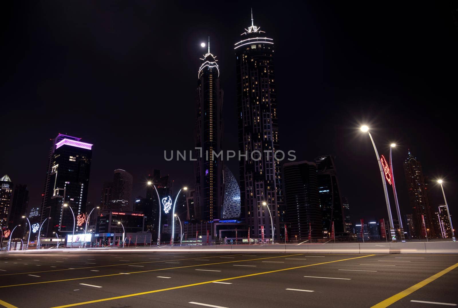 1ST jan 2021, Dubai , UAE.Moving traffic on the busy road with JW Marriott hotel and other sky scrappers in the background on a moonlit night captured at Dubai, UAE.