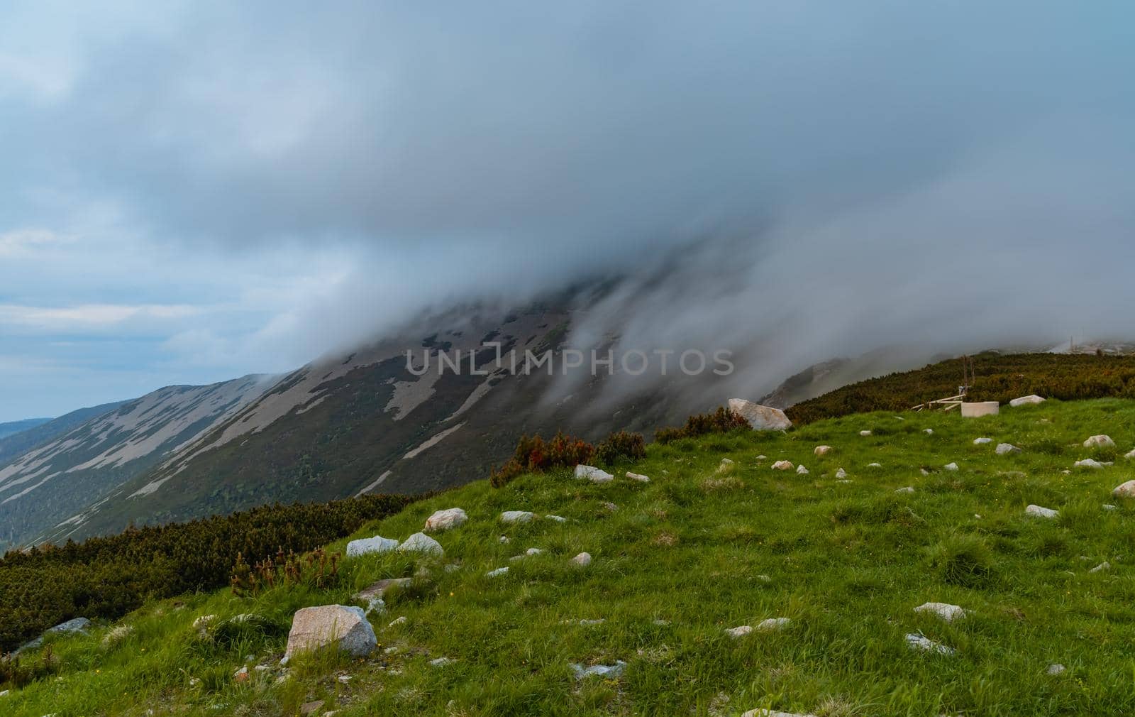 Clouds falling down to Sniezka mountain in Karkonosze Giant Mountains