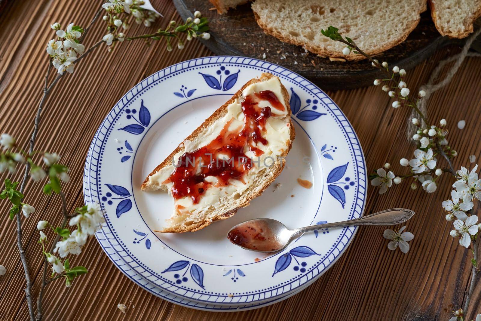 A slice of mazanec, traditional Czech sweet Easter pastry, with butter and marmalade