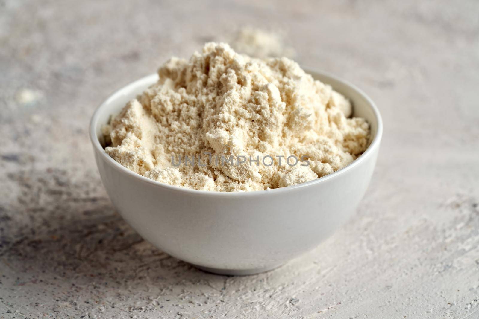 Whey protein powder in a white bowl