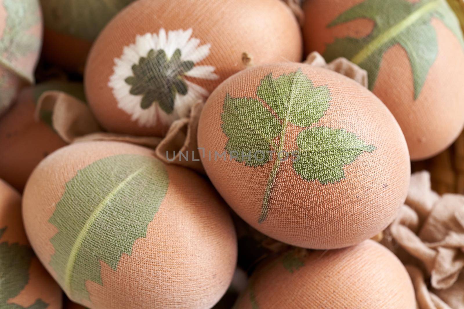 Preparation of Easter eggs for dyeing with onion peels with a pattern of plant, close up