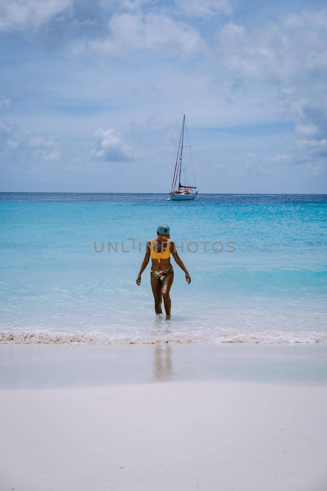 Small Curacao Island famous for day trips and snorkeling tours on white beaches blue clear ocean, Curacao Island in the Caribbean sea. woman on the beach during a vacation holiday