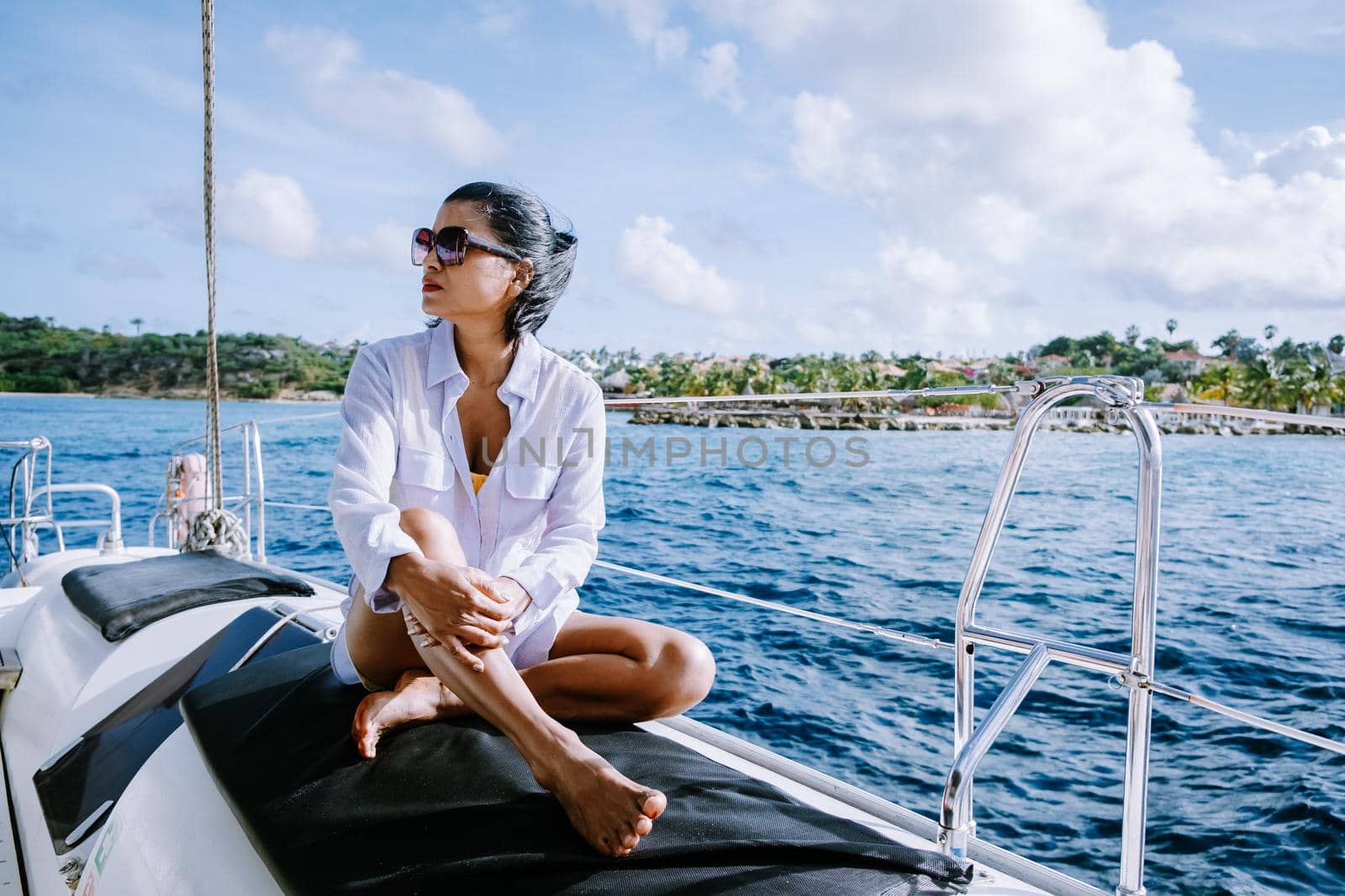 Small Curacao Island famous for day trips and snorkeling tours on white beaches blue clear ocean, Curacao Island in the Caribbean woman on sailing boat during a vacation holiday
