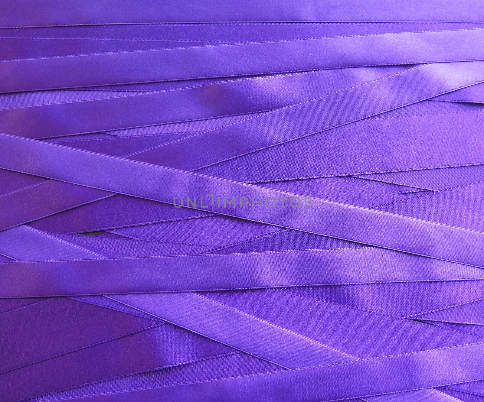 purple satin ribbons in a messy mess texture background