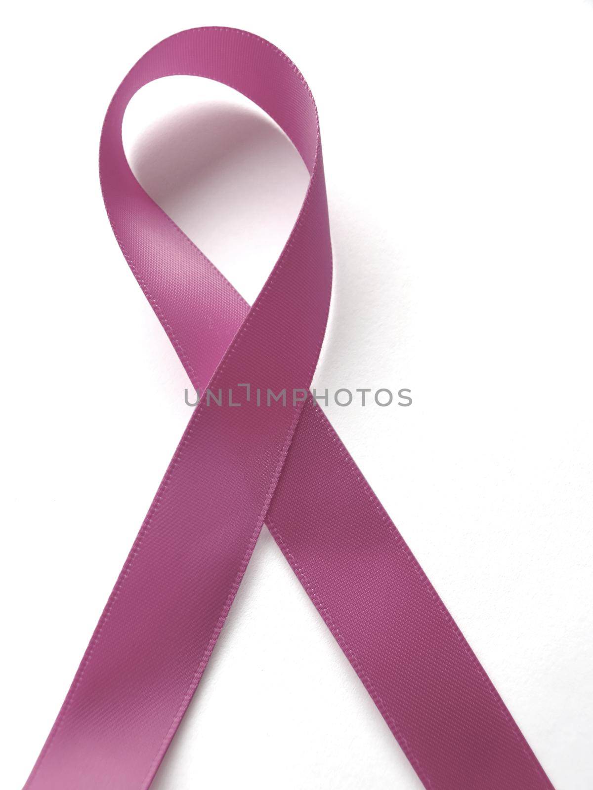 Pink ribbon against cancer isolated on white background by aroas