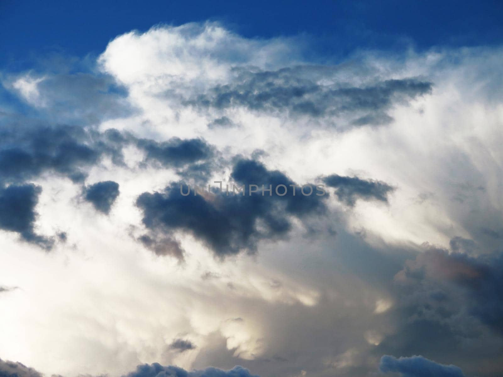 white fluffy clouds in the blue sky by aroas