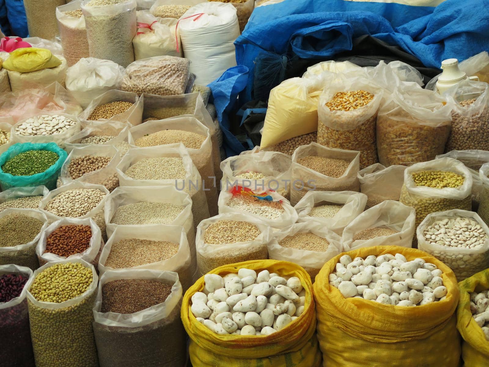 View on different assorted raw legumes in bags from above. Chick peas, beans, lentils