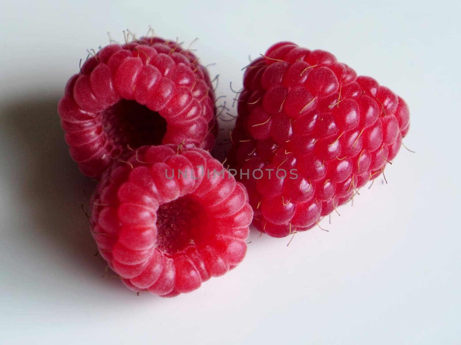 beautiful ripe raspberries on white background