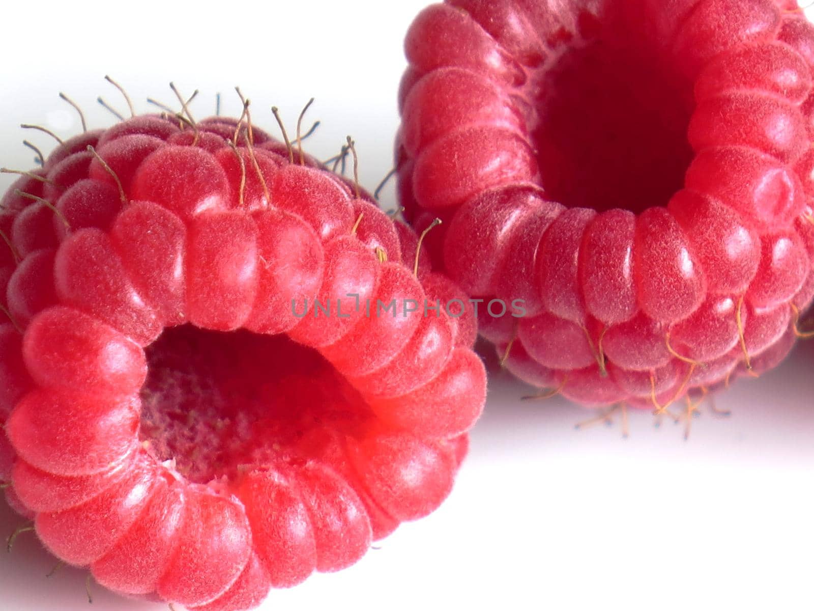 beautiful ripe raspberries on white background