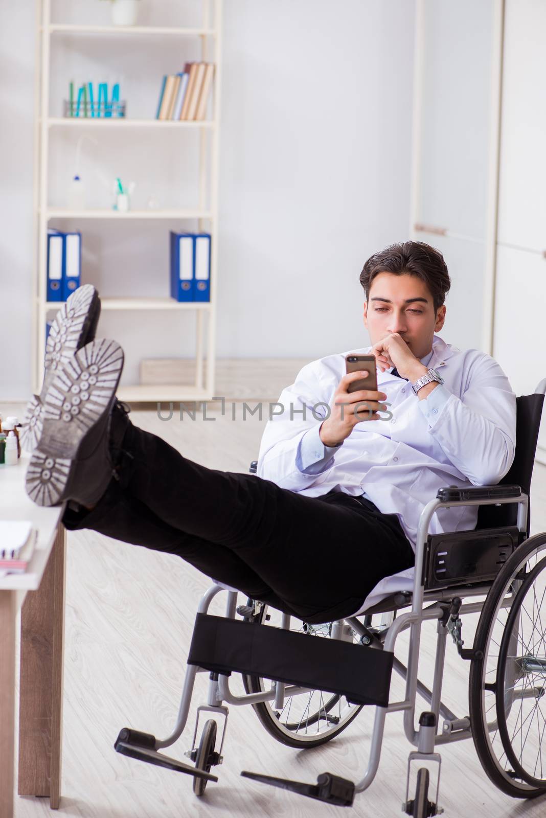 Doctor resting on wheelchair in hospital after night shift