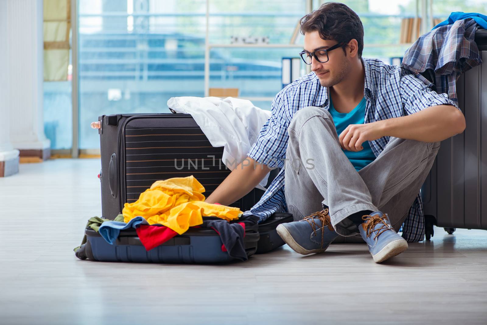 Young man preparing for vacation travel by Elnur