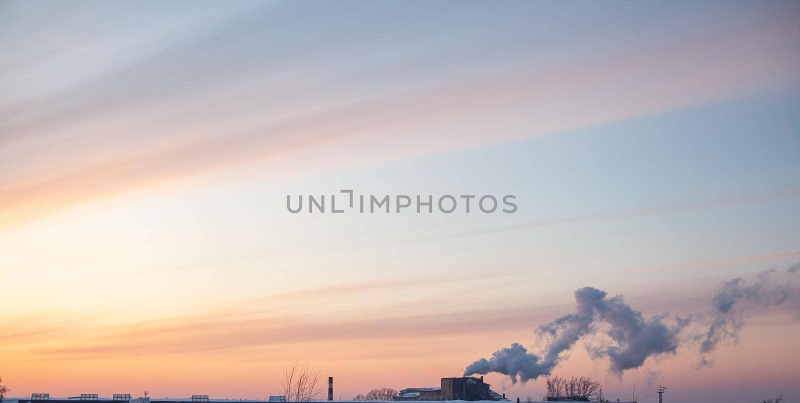 White thick smoke from the boiler room chimney. Smoke against the blue sky. Air pollution. Heating of the city. Industrial zone.