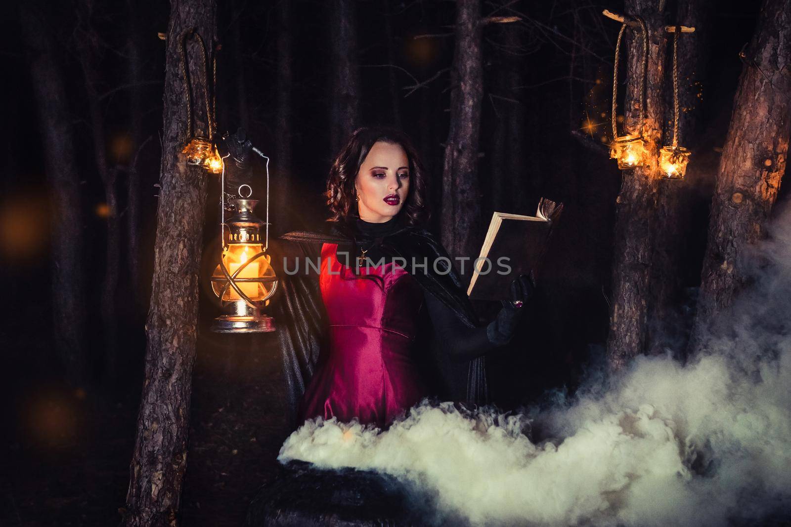 girl alone at night in the forest brews a potion and wonders for marriage, surrounded by candles and smoke